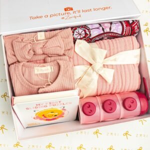 Adorable baby gift box featuring pink clothing, a puzzle book, and storage containers.